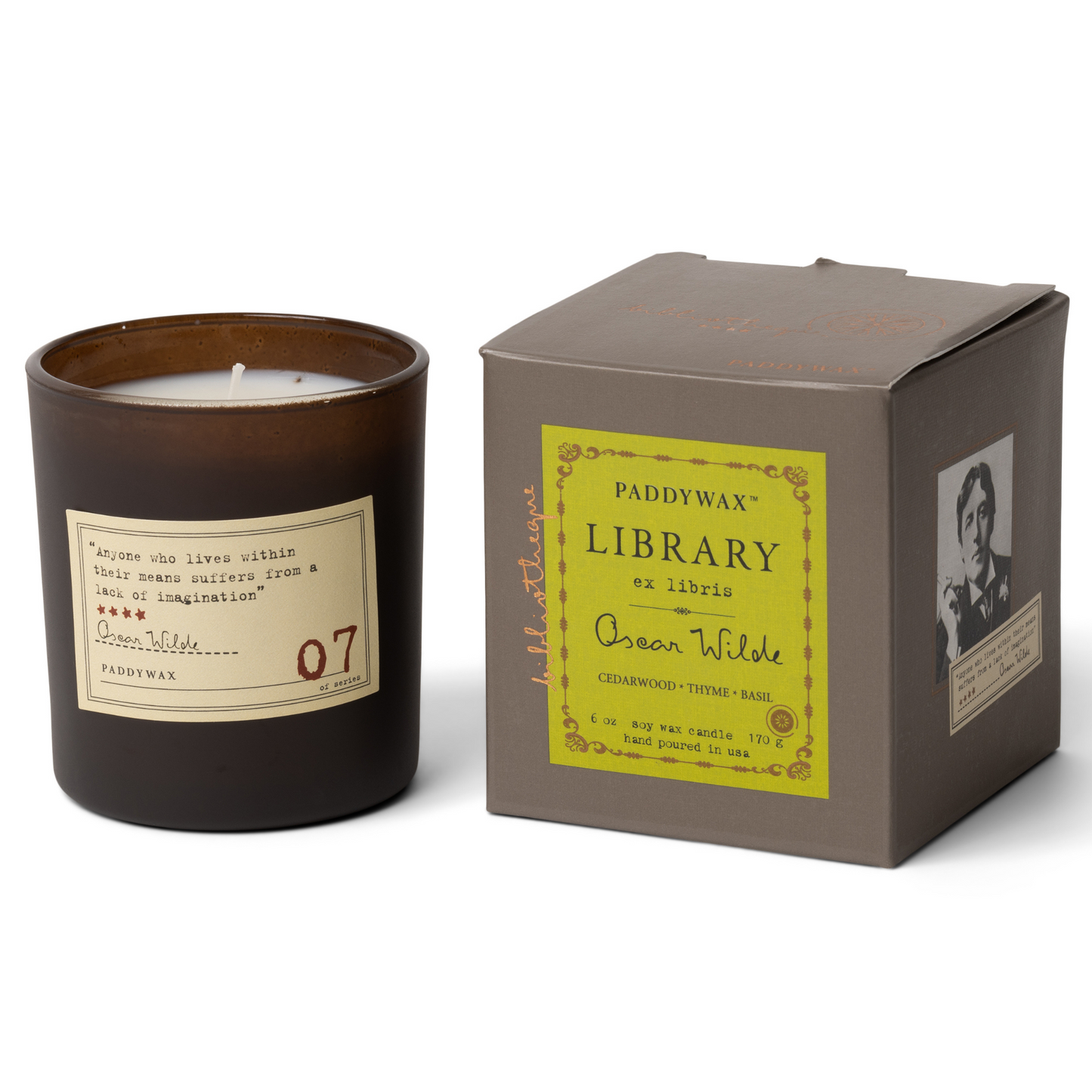 Black candle next to grey box with green label on front.