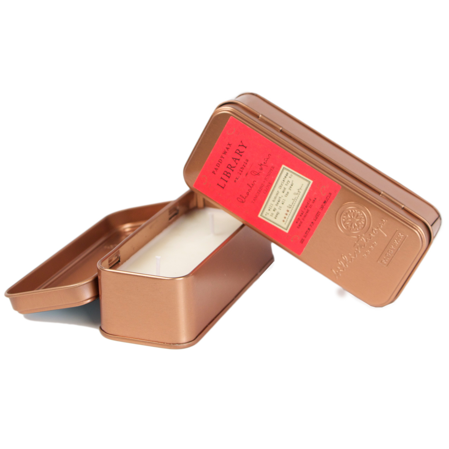 Two copper tined candles leaning on each other.