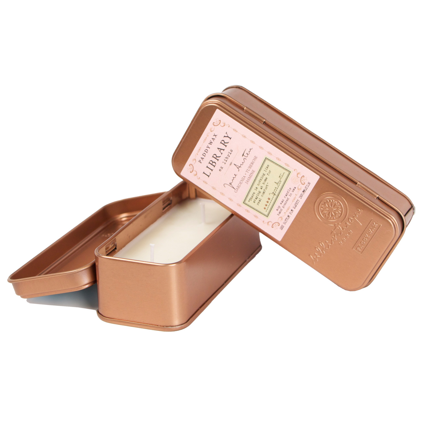 Two copper tined candles leaning on each other.