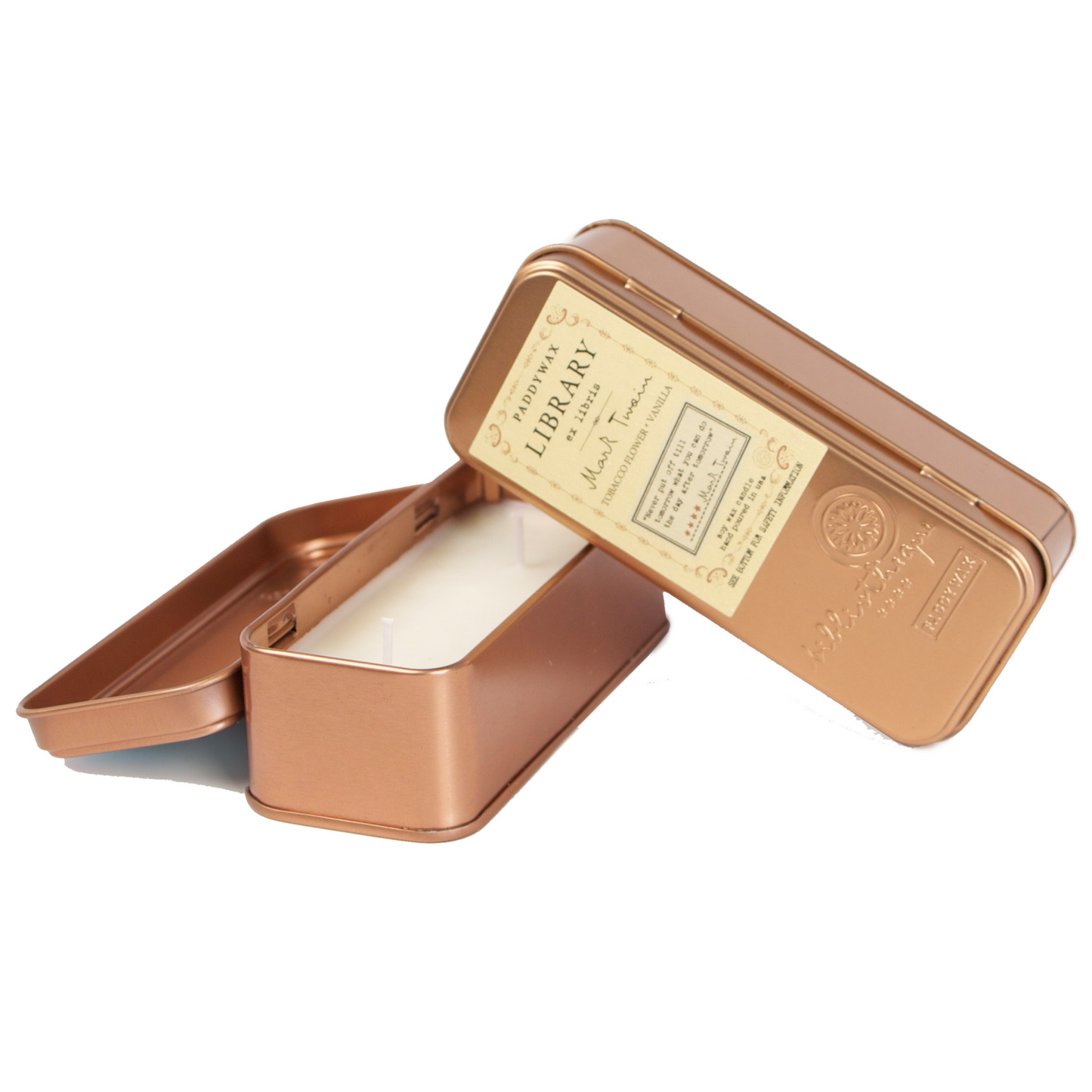 Two copper tined candles leaning on each other.