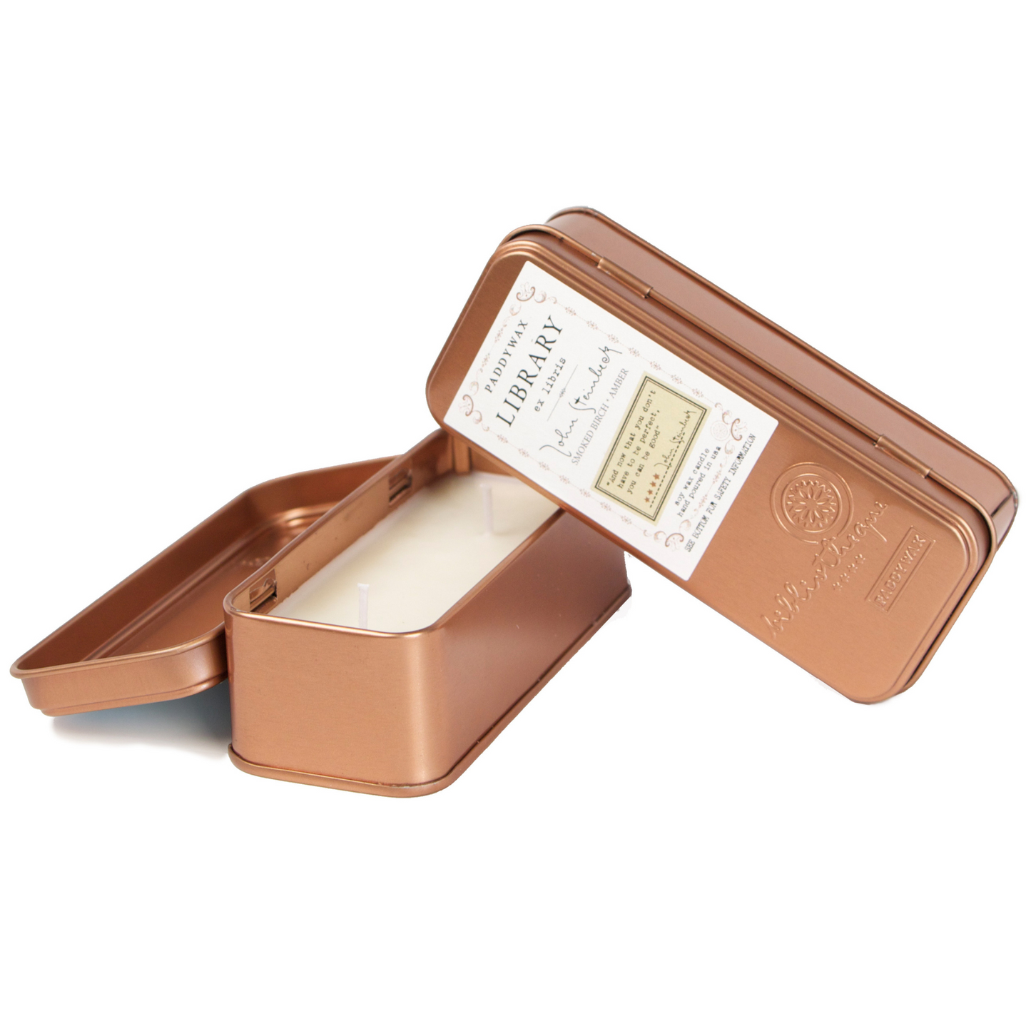 Two copper tined candles leaning on each other.