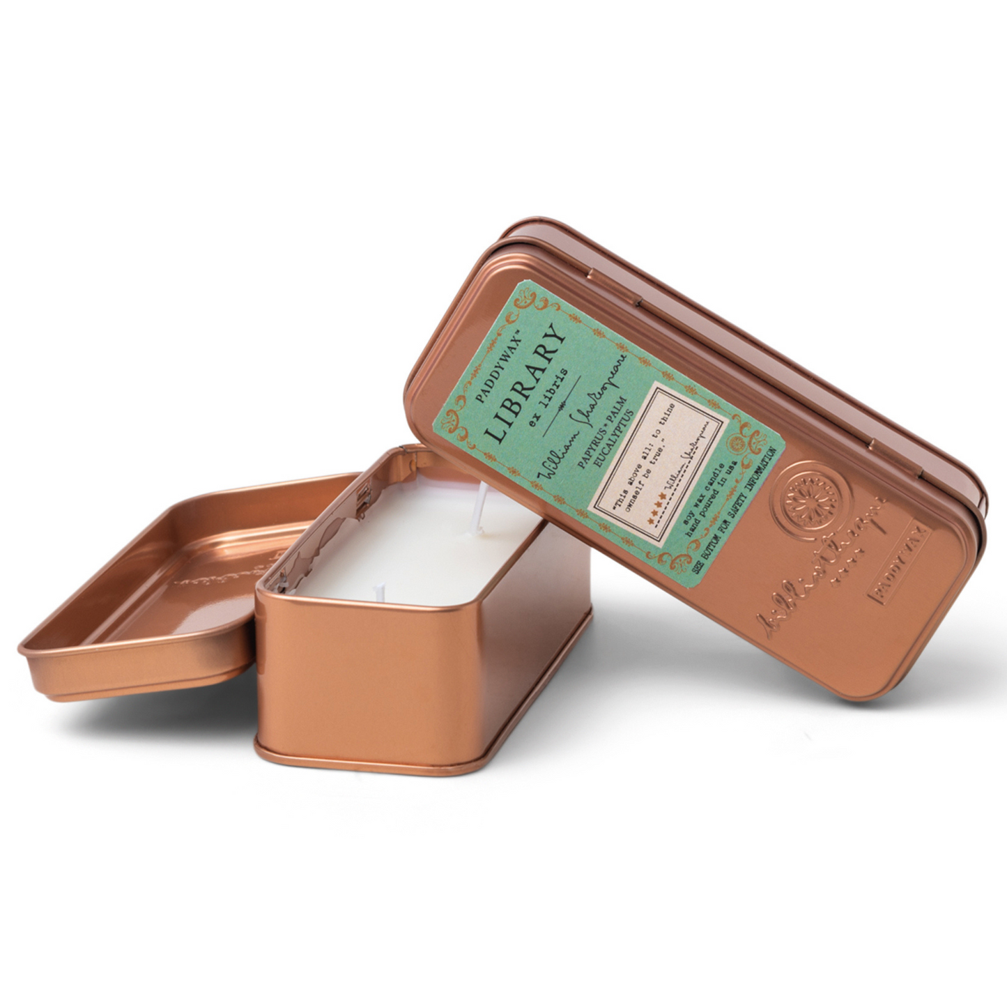 Two copper tined candles leaning on each other.