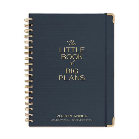 black coloured planner with text written on the front in gold.