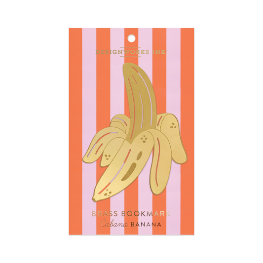 banana shaped bookmark in gold packaged in a pink and orange striped slip. on a white background.