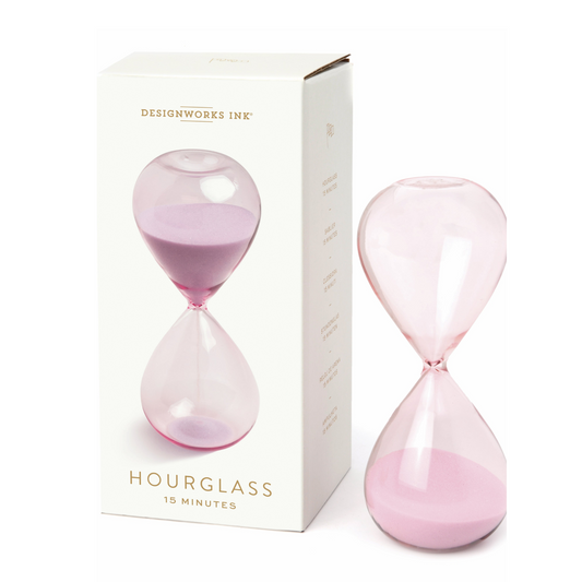 pink hourglass standing next to a cream box with an image of the hourglass printed on the front.