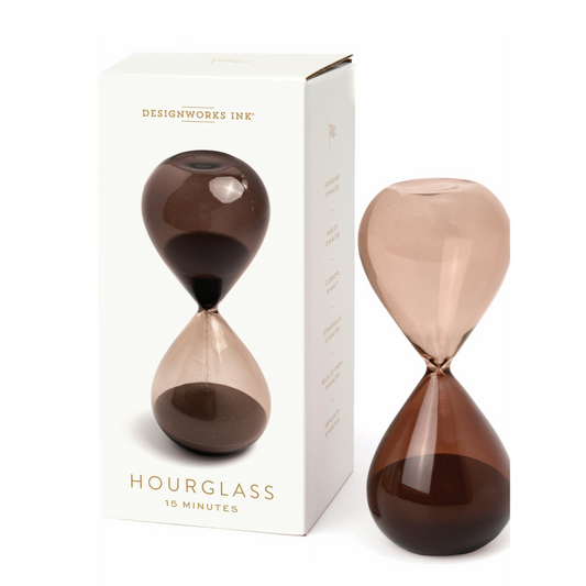 brown hourglass standing next to a cream box with an image of the hourglass printed on the front.