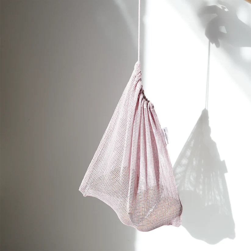Hanging pink produce bag on a plain white background.