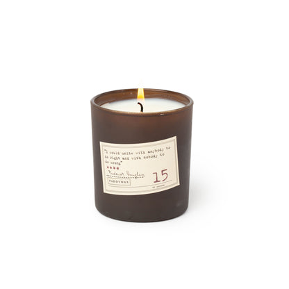 black candle with cream label on the front